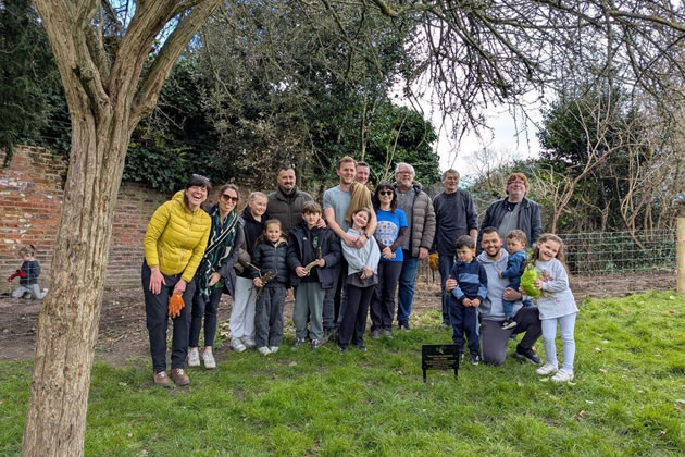 Oussama (kneeling, far right) with his family and volunteers on planting day
